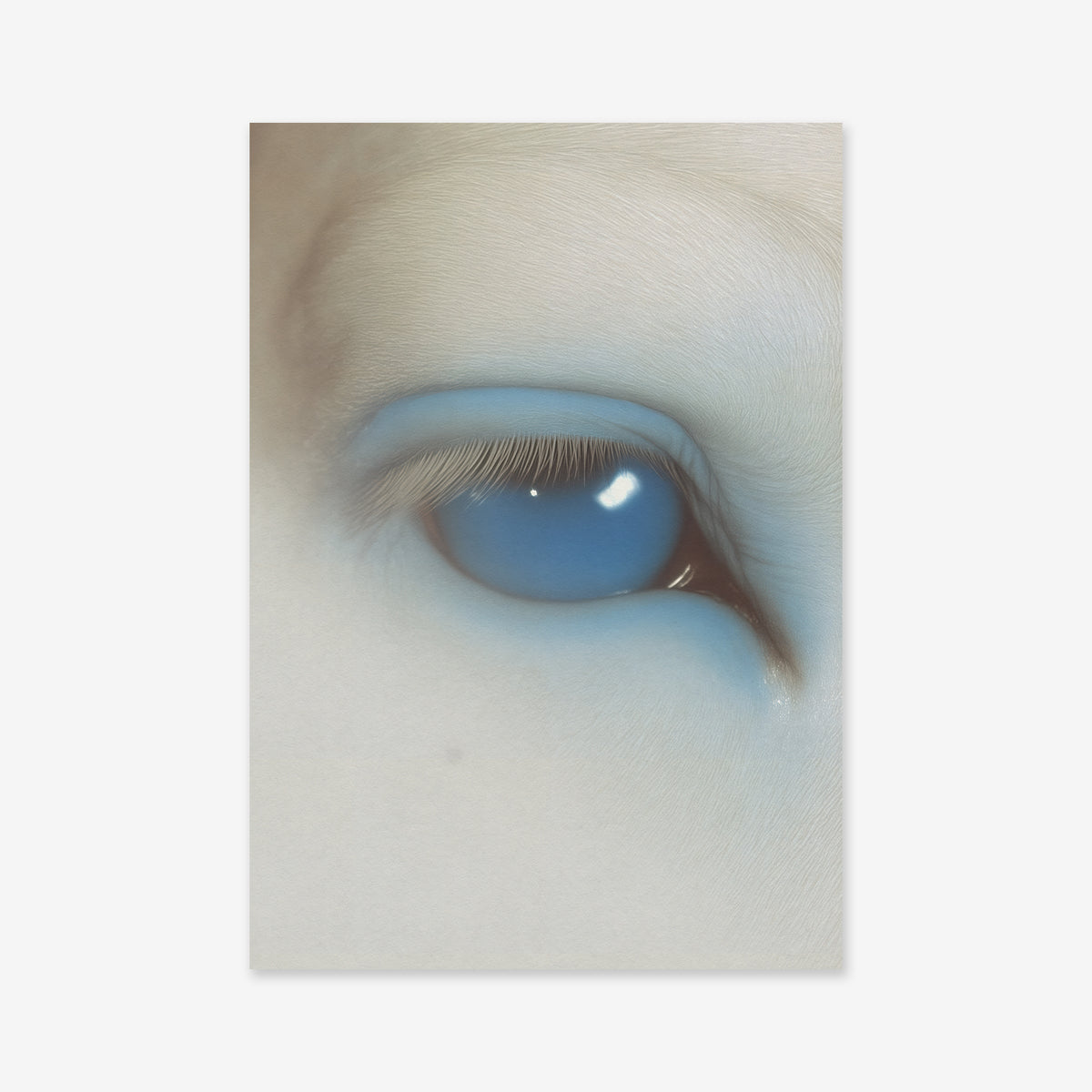 Eye of the beast" is a Giclée art print on archival paper featuring a close-up of a partially closed eye with pale skin and a vivid blue eyelid and sclera, creating a surreal, otherworldly effect—perfect for modern interiors.