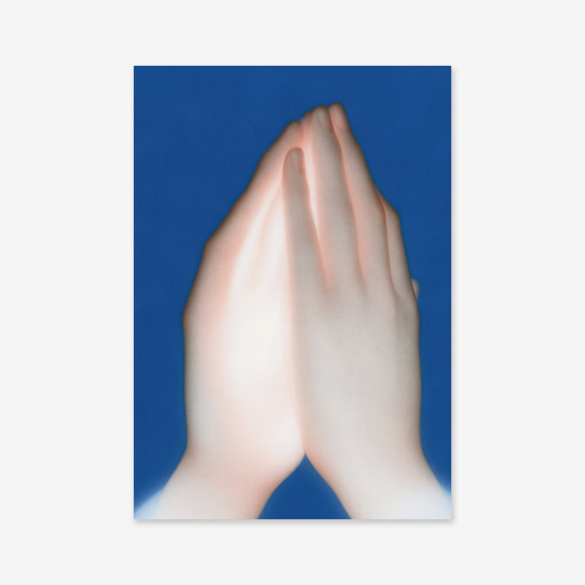 Praying hands features two pressed hands in a praying gesture on a deep blue background, softly lit as a giclée art print—perfect for bringing serenity to any modern interior.